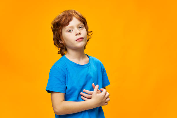 istock Red-haired child in a blue T-shirt side view 2189795728