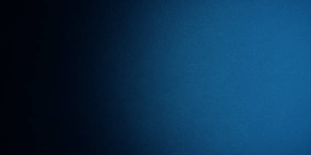 istock Blue grainy gradient noisy background, light to dark azure sapphire cerulean denim blue smooth noise texture banner backdrop design 2189796454