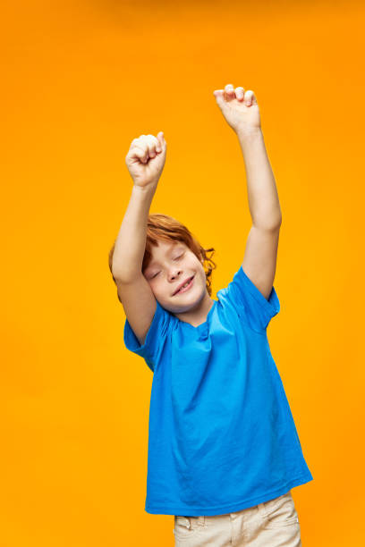 istock Happy with raised hands red hair blue t-shirt 2189796777