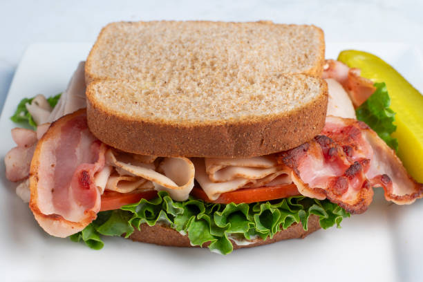 istock turkey blt sandwich  served with a pickle 2189797340