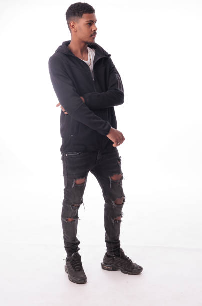 istock Young man posing wearing black clothes with crossed arms and looking away 2189797574