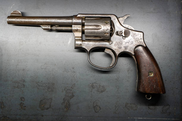 istock Pistol revolver. Gun gray background 2189798102