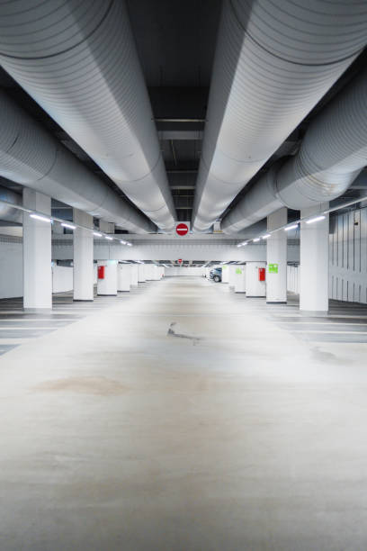 Spacious Underground Parking Garage with Illuminated Ceiling and Empty Lanes