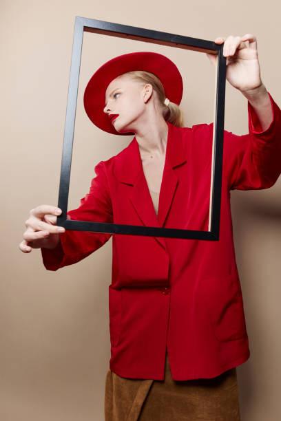 istock pretty woman frame in hand in red hat and jacket isolated background 2189798403