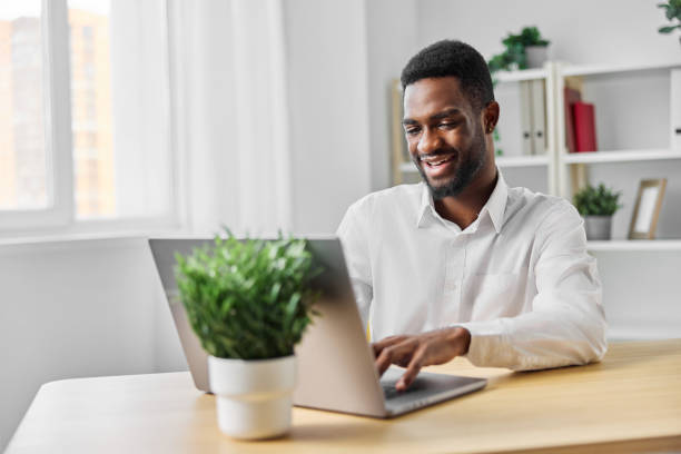 istock man student office cyberspace african computer freelancer job laptop education american online 2189799499