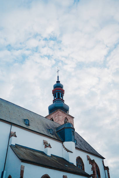 Historical Church Steeple Surrounded by a Clouded Sky Captures Serene Architecture with a Gothic Influence
