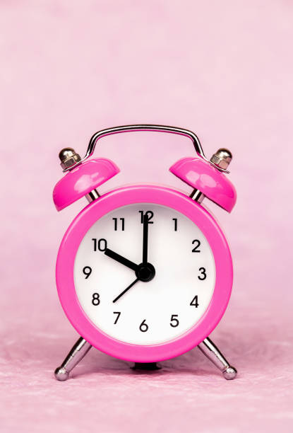 istock Pink alarm clock, time saving and management background 2189799803