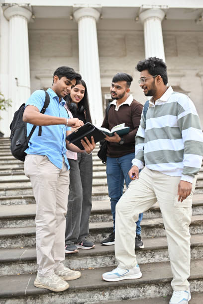 istock University students, studying and discussing standing on the steps of the campus 2189800035