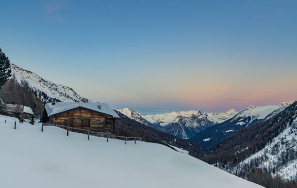 Aerial view of snow covered ski hill at sunrise, Swiss Alps