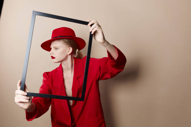 istock glamorous woman frame in hand in red hat and jacket Lifestyle posing 2189802100