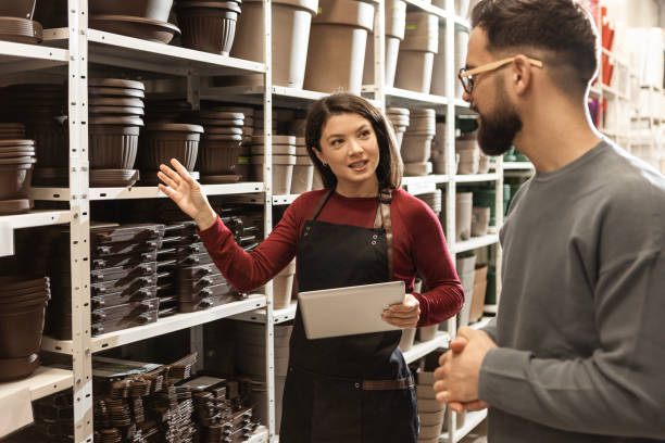 istock Male Customer Browsing Flower Pots with Saleswoman’s Help 2189803641