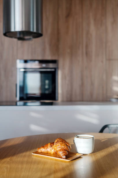 istock Enjoying a cozy breakfast with fresh croissants and coffee at home 2189805476
