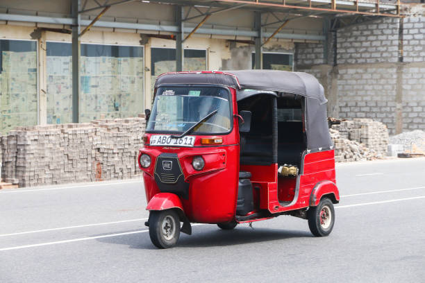 Bajaj RE Colombo, Sri Lanka - September 27, 2024: Red auto rickshaw Bajaj RE in the city street. taxi sri lanka stock pictures, royalty-free photos & images