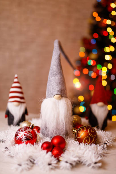 istock Festive Christmas Gnome Decorations with Ornaments and Bokeh Christmas Tree in Background 2189816821