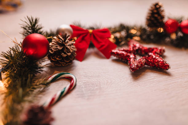 A festive arrangement of Christmas decorations including red stars, pine cones, and holiday motifs. Perfect for seasonal themes, holiday celebrations, and creating warm Christmas atmospheres.