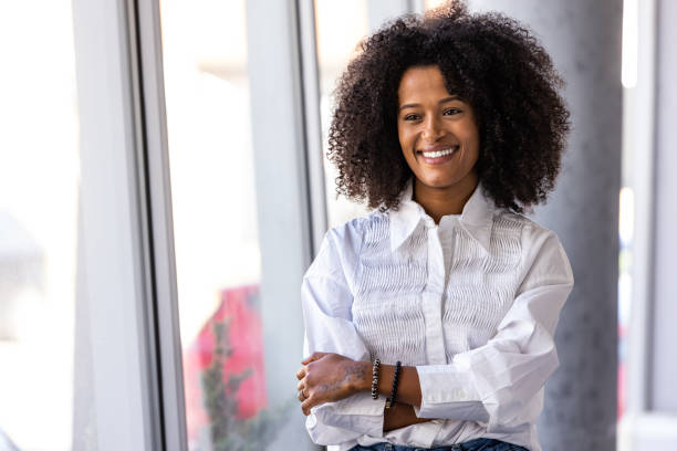 istock Confident Woman Smiling in a Bright Office Setting 2189818162