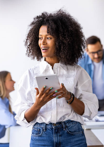 istock Confident Businesswoman Using Tablet During Team Meeting 2189818164