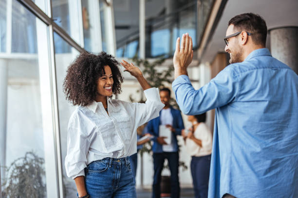 istock Two Colleagues Celebrating Success with a Joyful High Five 2189818202