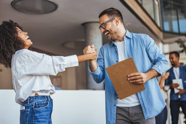 istock Happy Coworkers Celebrating Success with a Friendly Handshake 2189818207