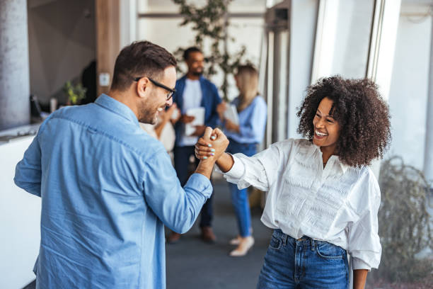 istock Colleagues Sharing a Joyful Fist Bump in Modern Office Setting 2189818217