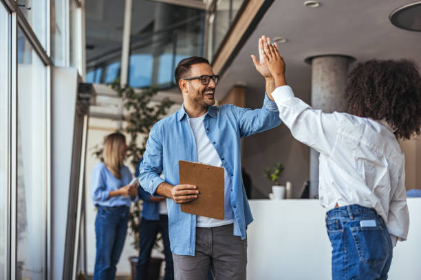 istock Happy Office Team Celebrating Success With High Five 2189818226