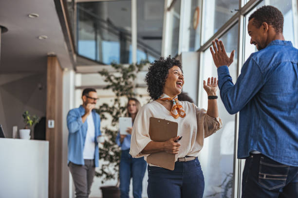 Colleagues Celebrating Success with High Five in Modern Office