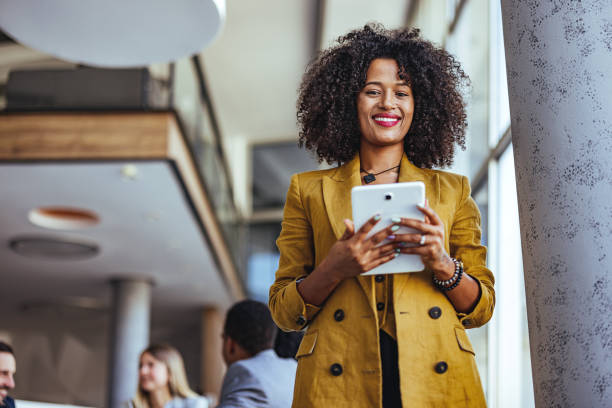 istock Confident Businesswoman Smiling While Using a Tablet in Office 2189818249