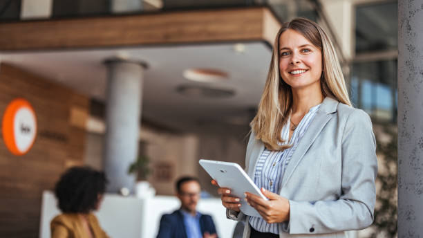 istock Confident Business Woman Holding Tablet in Modern Office Setting 2189818265