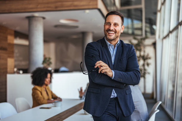 istock Confident Businessman Smiling in Modern Office Environment 2189818269