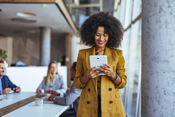 istock Confident Businesswoman Smiling While Using Tablet in Office Meeting 2189818275