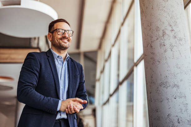 istock Confident Businessman Smiling Brightly in Modern Office Environment 2189818277