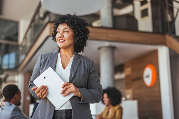 istock Confident Businesswoman Holding Tablet in Modern Office Setting 2189818284