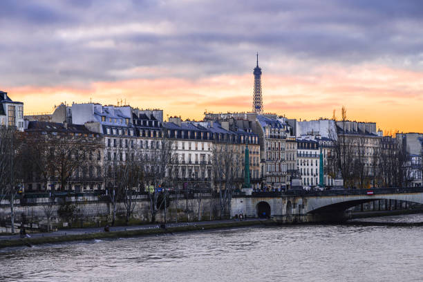 Paris: Quai de Seine with view of a sunset with the Eiffel Tow. Paris in France, November 30, 2024.