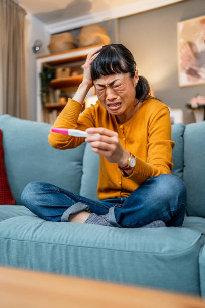 istock Upset woman with negative pregnancy test 2189820084