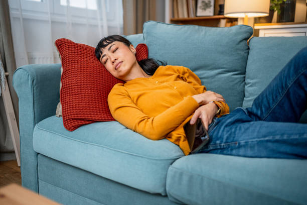 istock Tired woman taking a nap on the sofa 2189820370