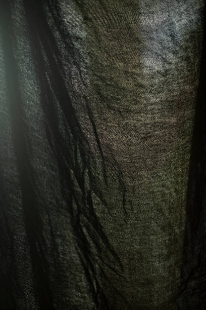 istock Curtains on window. Light through dark fabric. Texture of fabric in light. 2189820660