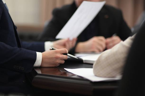 istock Business Meeting, man's hand with pen 2189821470