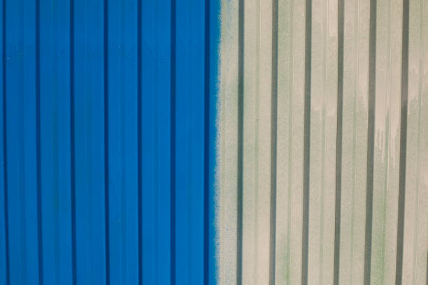Painted fence. Paint on steel profile. Paint layer on steel. A Fresh Trace of Blue.