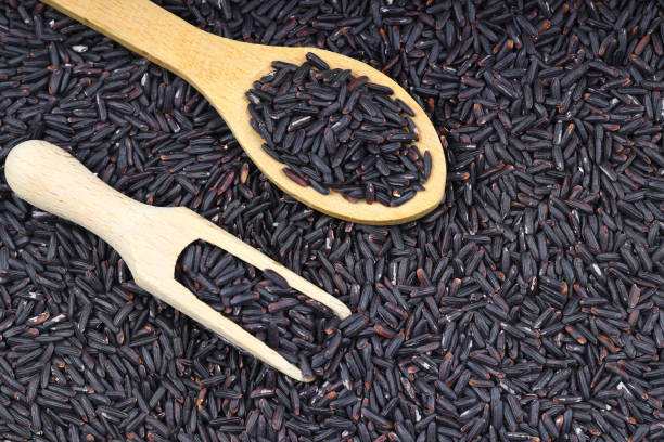 istock Black wild rice with bamboo spoon on wooden background 2189822110
