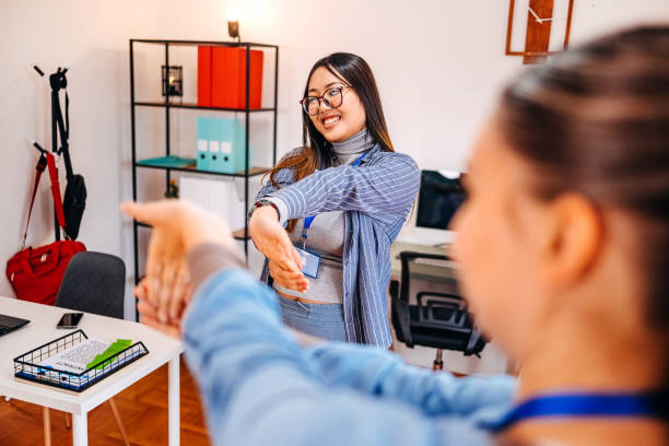 istock Colleagues exercising together while on a break in office and showing stretching exercise 2189823361