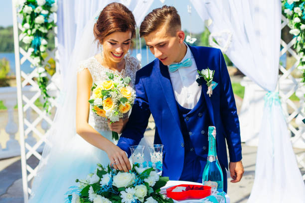 istock Bride and groom near arch with wedding decorations. table with w 2189836612