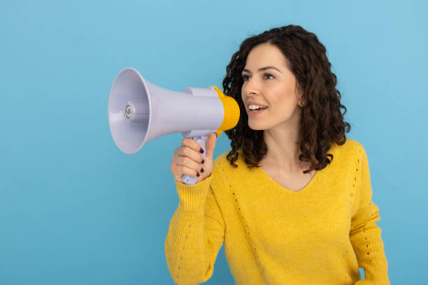 istock Confident young Latina woman holding a megaphone 2189837106