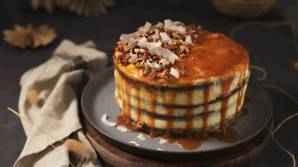 istock Layered cake drizzled with caramel sauce, topped with pecans and coconut flakes 2189841063