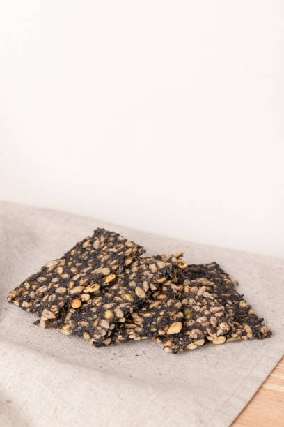 istock Crispy homemade crackers with seeds on light background 2189849033