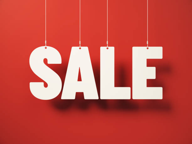 istock SALE wording cut on white note paper hanging on string, White note paper on a red Background. 2189850478
