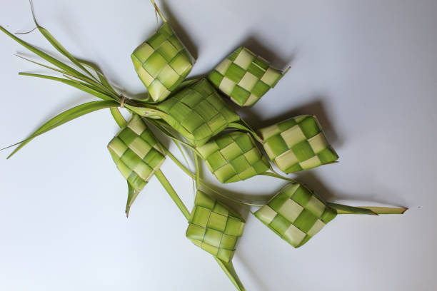istock Ketupat wrap, woven young coconut leaves, before cooked. Isolated on white background 2189859066