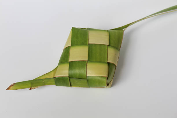 istock Ketupat wrap, woven young coconut leaves, before cooked. Isolated on white background 2189859068