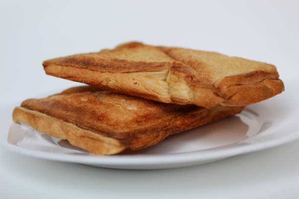 Some toasts or toasted breads, on white plate, isolated on white background
