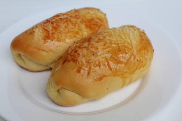 istock Two baked bread with grated cheese on top, on white plate, isolated on white background 2189859258