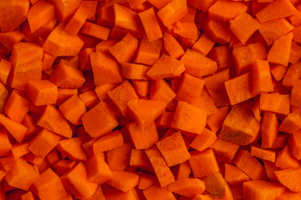 istock Fresh carrots cut into small cubes as a background for a vegan concept 2189872763